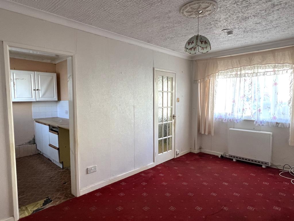 Lot: 107 - GROUND FLOOR FLAT FOR REFURBISHMENT - View of living room showing door to kitchen